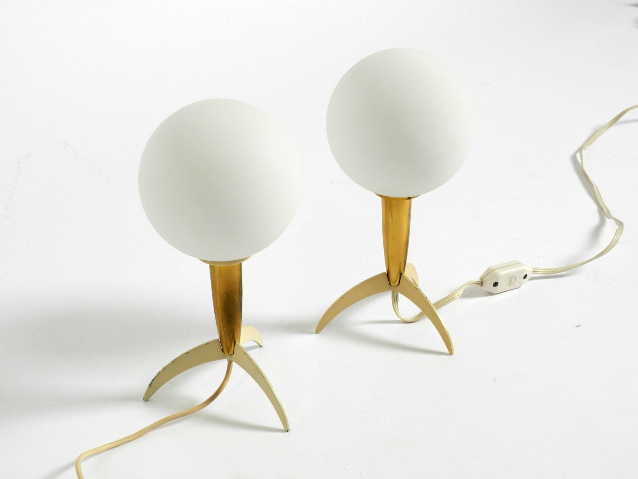 Two Mid-Century Modern rocket table lamps in brass and glass