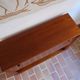 Vintage teak bar cabinet with black glass interior.