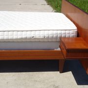 Vintage bed in teak with integrated bedside table.