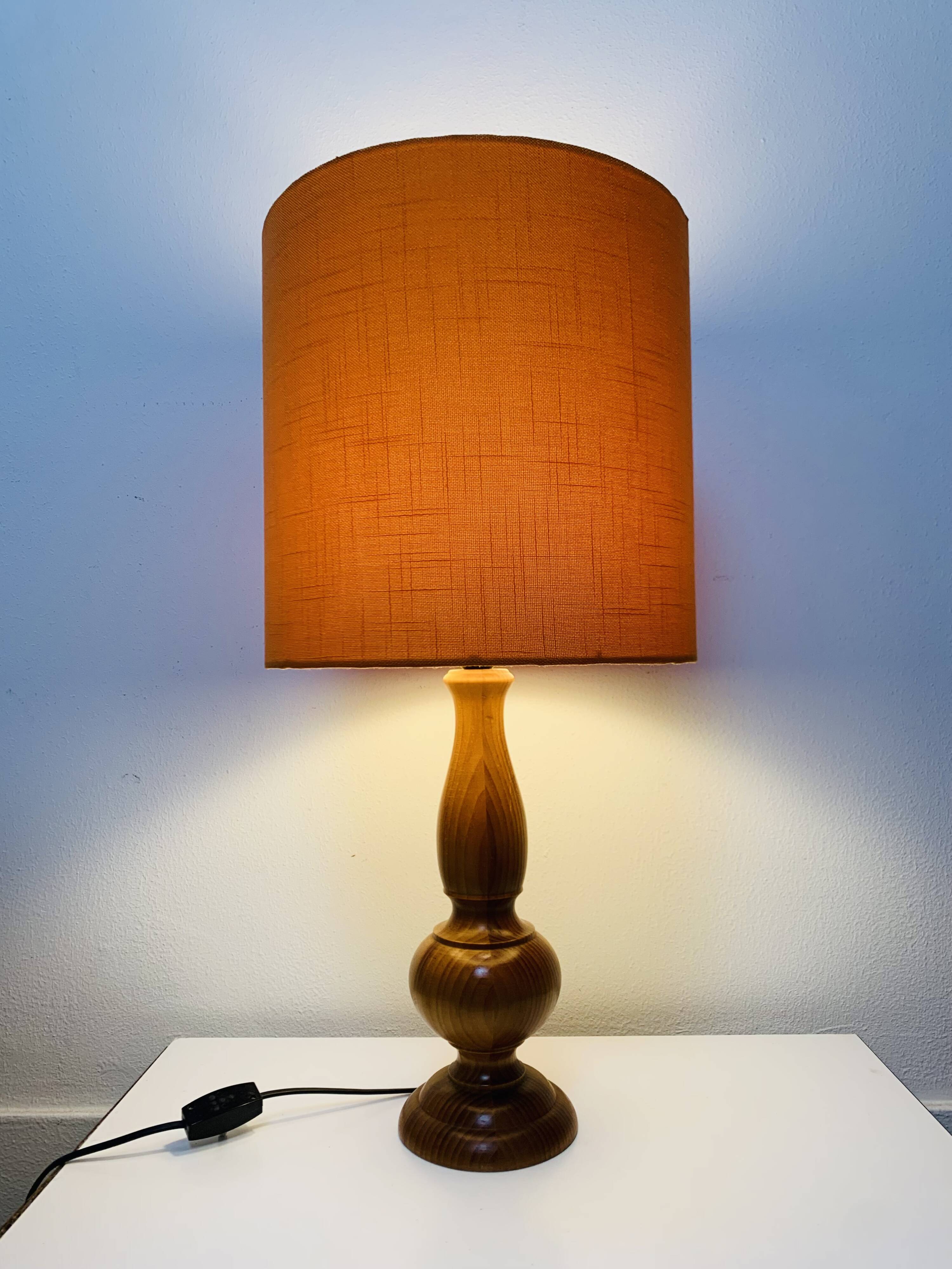 Turned wood lamp with orange shade, 1970s.