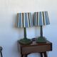 Pair of vintage wooden lamps with their striped beige, blue, and green shades.