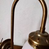 Brass wall lamp with pale pink bell