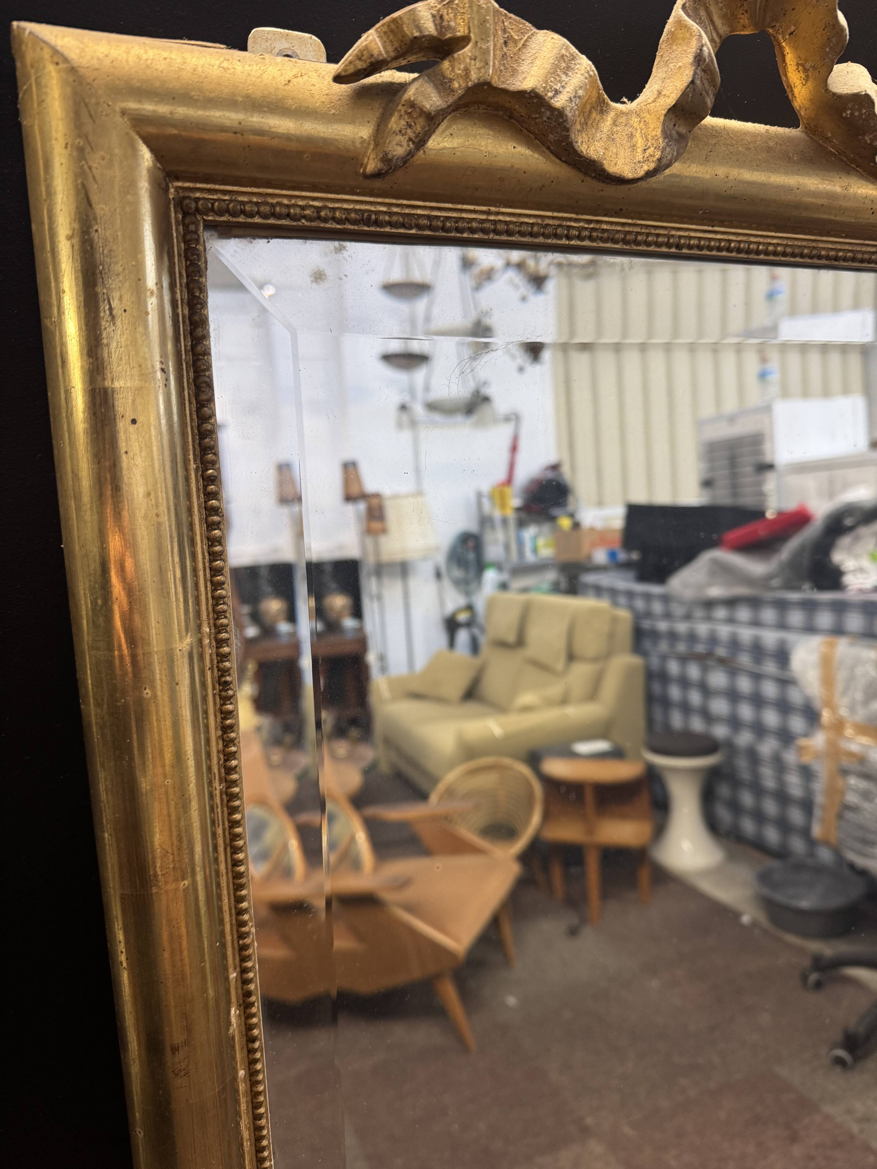 Large mirror with a gold frame