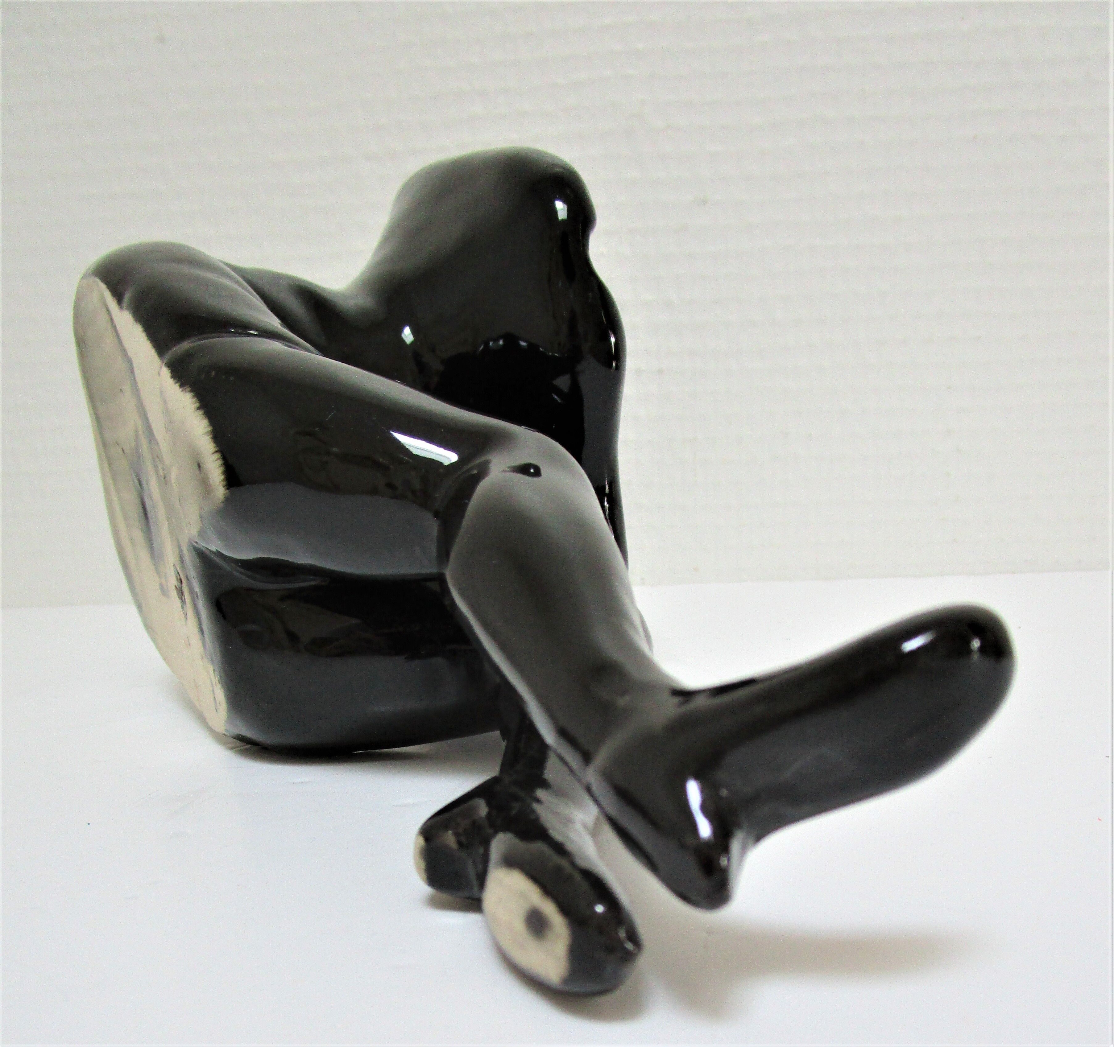 Anthropomorphic ashtray legs ceramic black design 80s