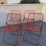 4 red 70s chairs