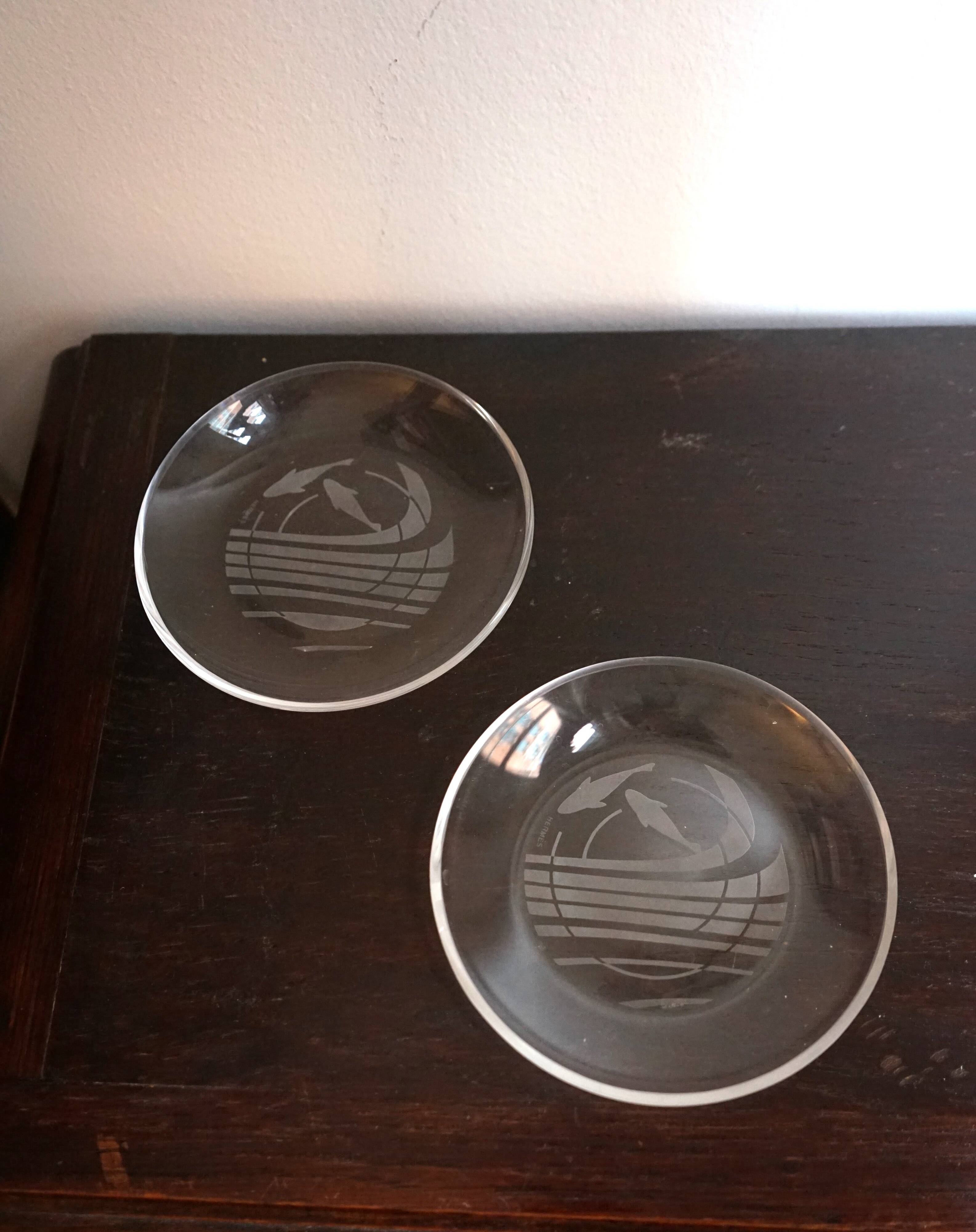 Hermès pair of glass plates with a dolphin pattern.