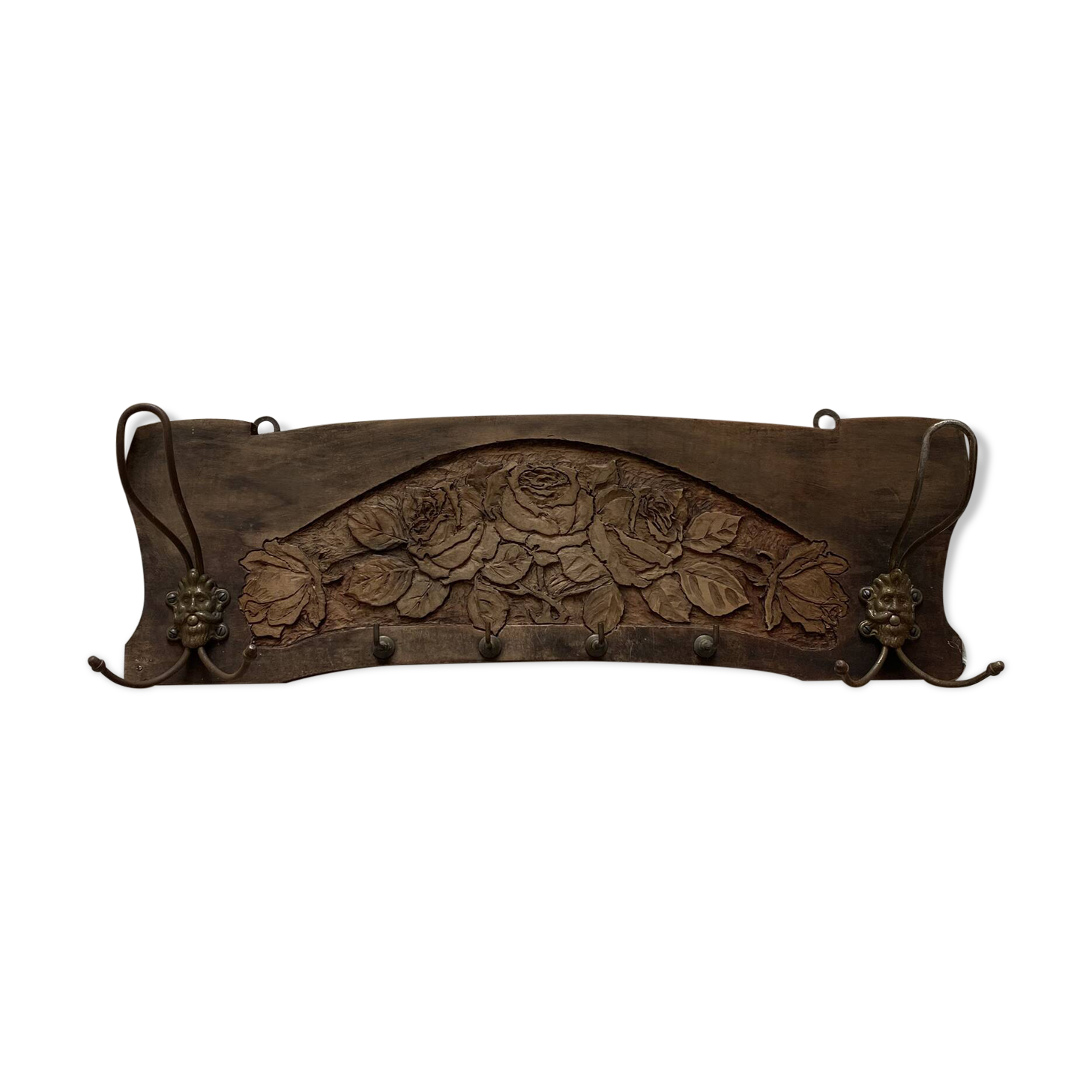 Wall-mounted coat rack in carved wood with rose decoration.