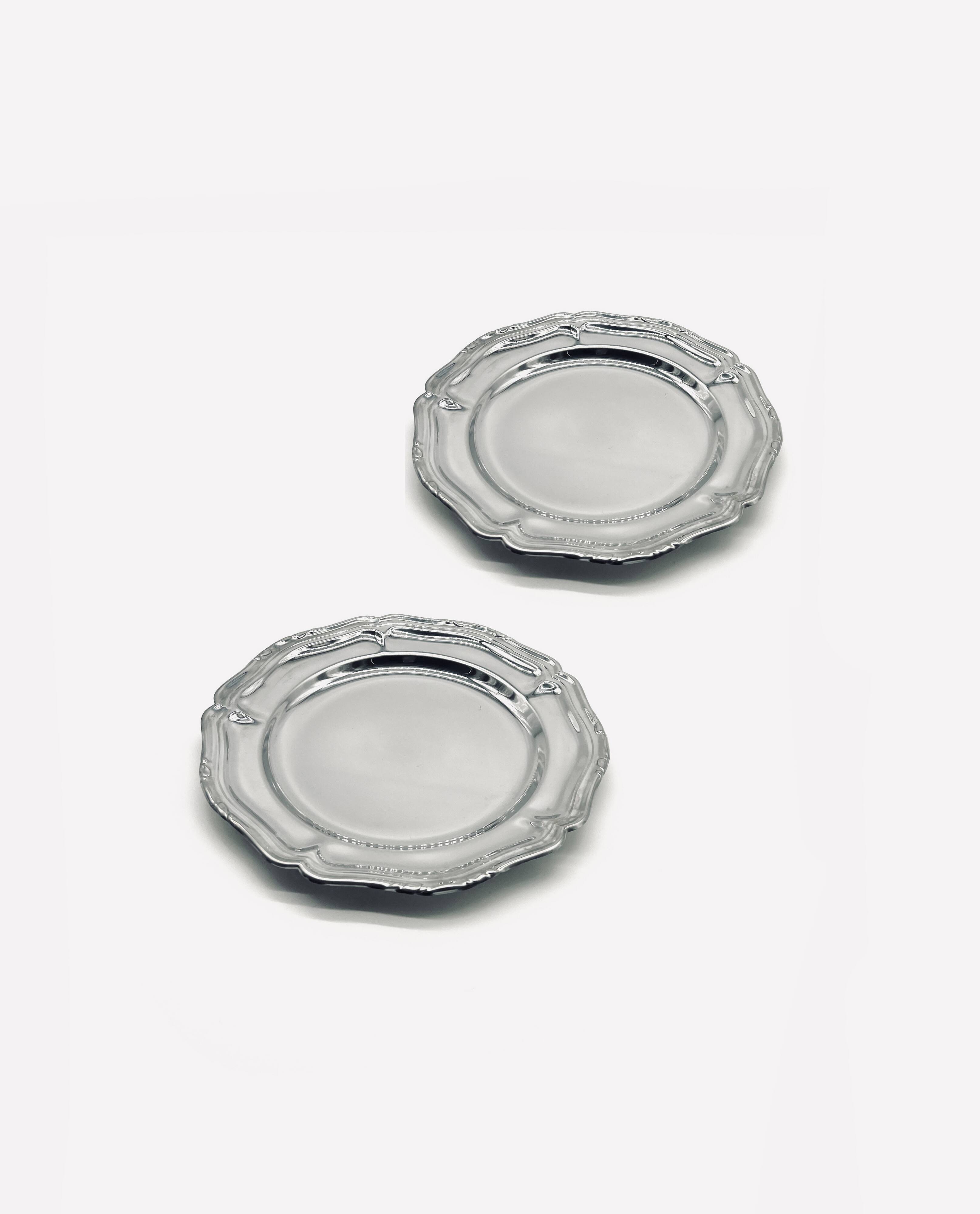 Two small stainless steel dishes