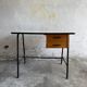 Black metal and wood mid-century industrial desk with laminated top and two drawers