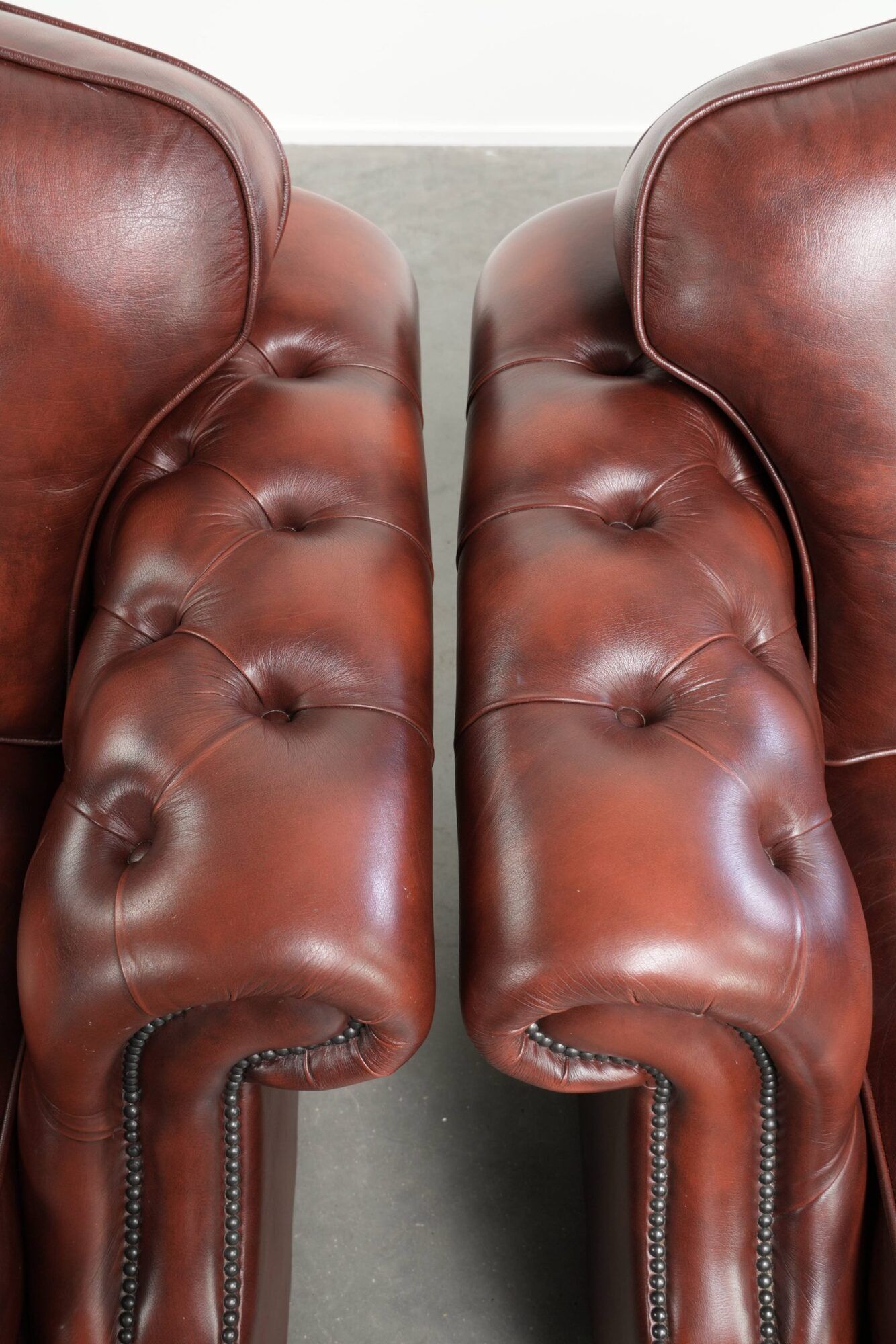 Vintage set of 2 cowhide leather Chesterfield armchairs in a brown colour