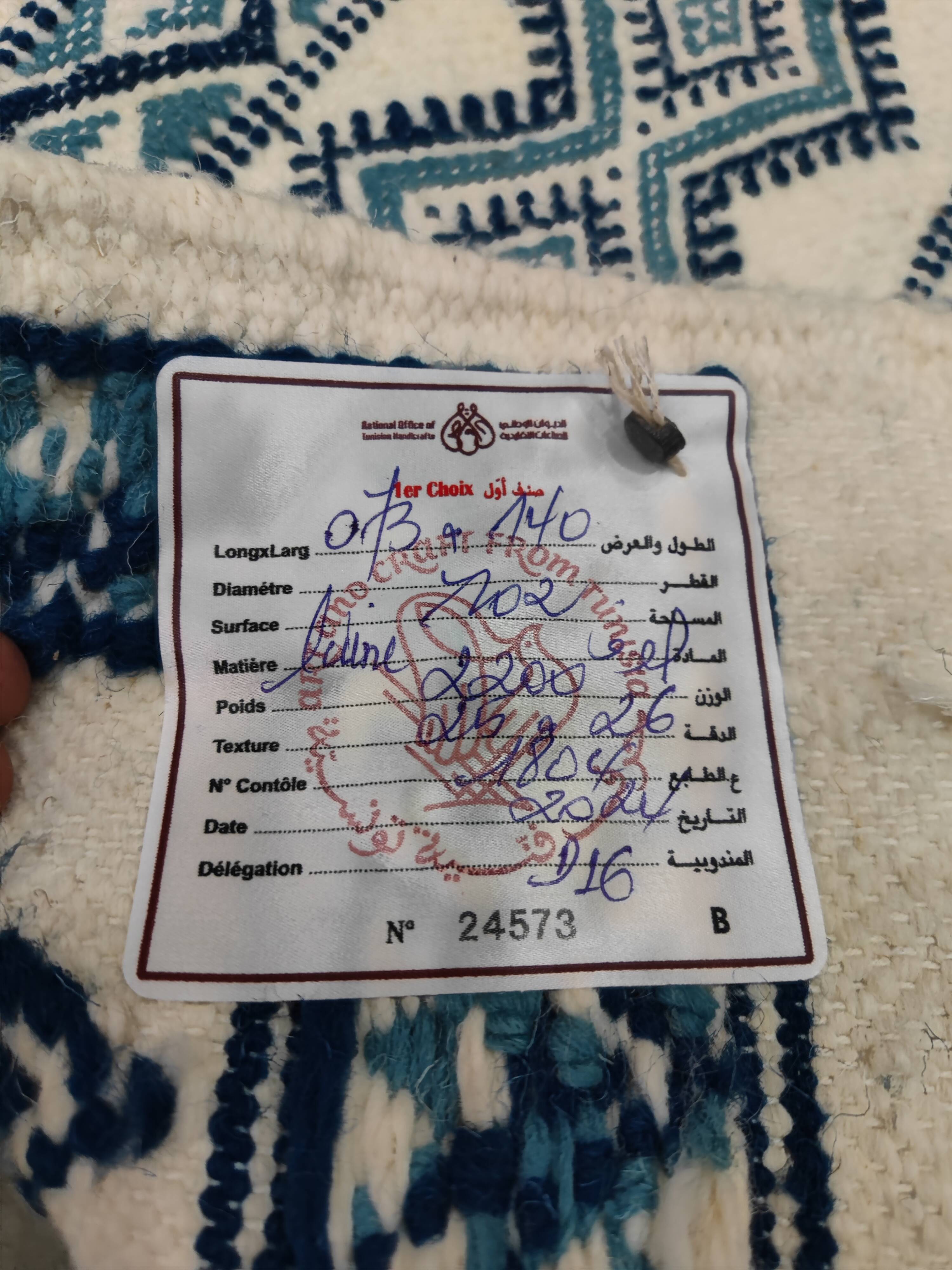 White and blue hand-woven rug in natural wool