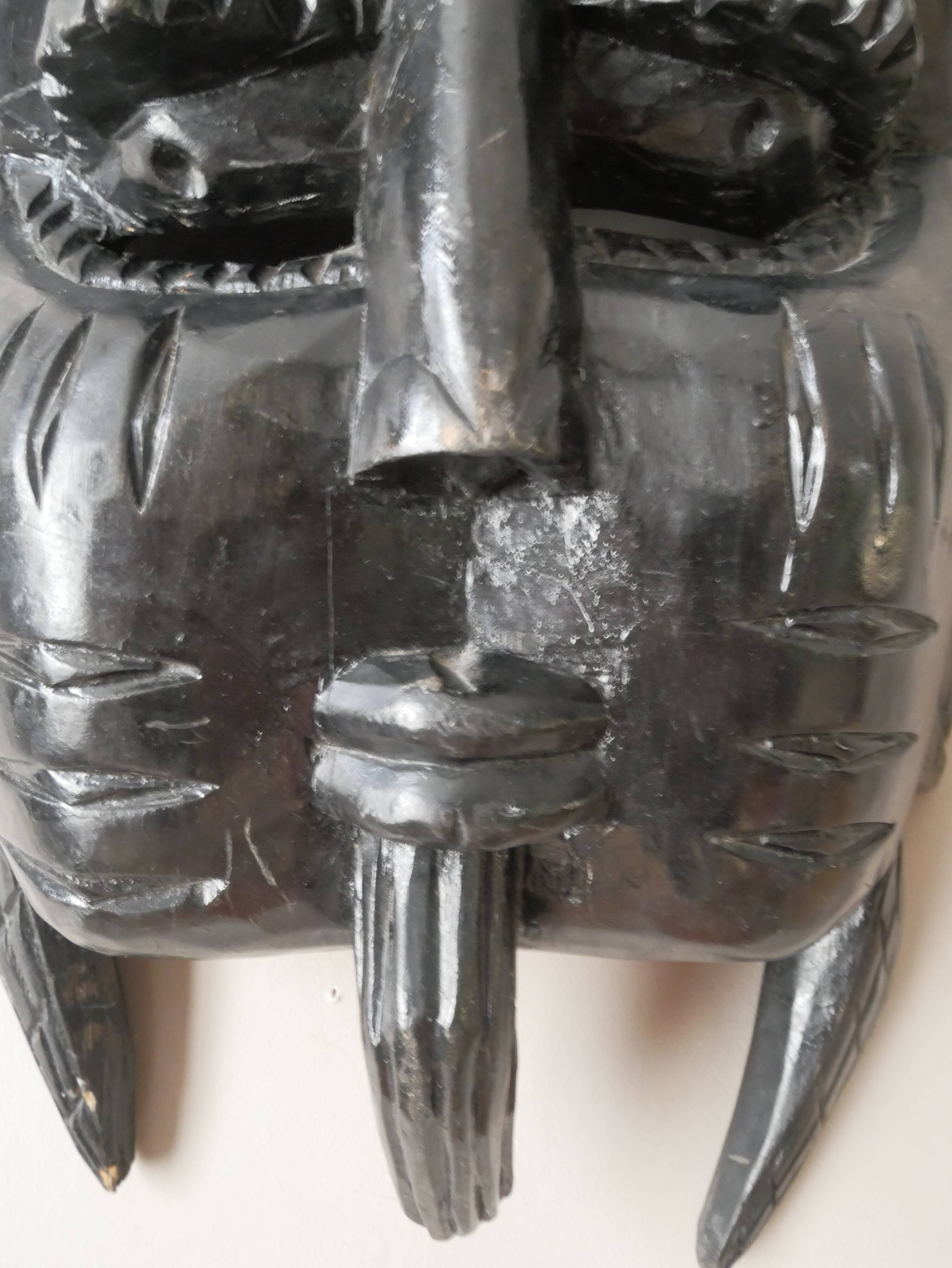 Decorative mask hand carved in tribal ethnic painted wood