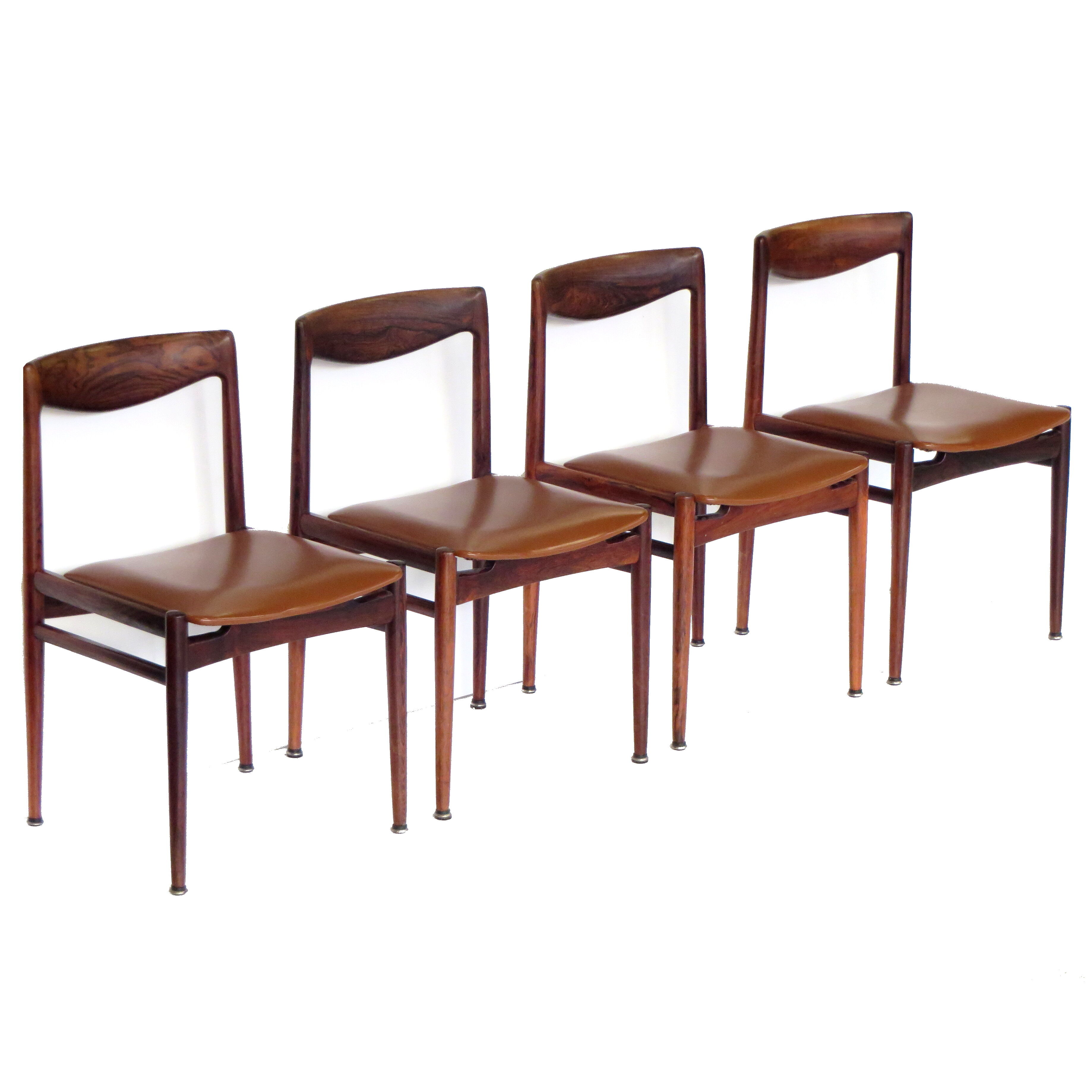 Set of four vintage mid century rosewood dining chairs with cognac leather seats