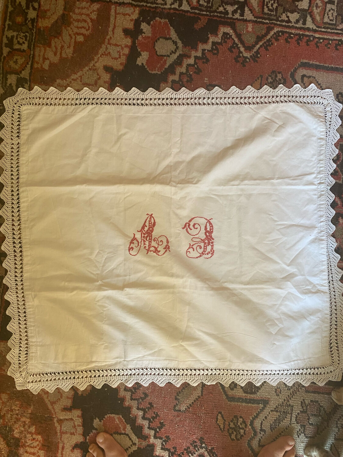 Antique white cotton pillowcase with crochet and monogram.