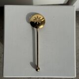 Small golden glass ice bucket with diamond point design and its scoop.