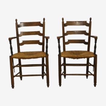 Pair of armchairs in solid oak and straw two-tone carved armrests.