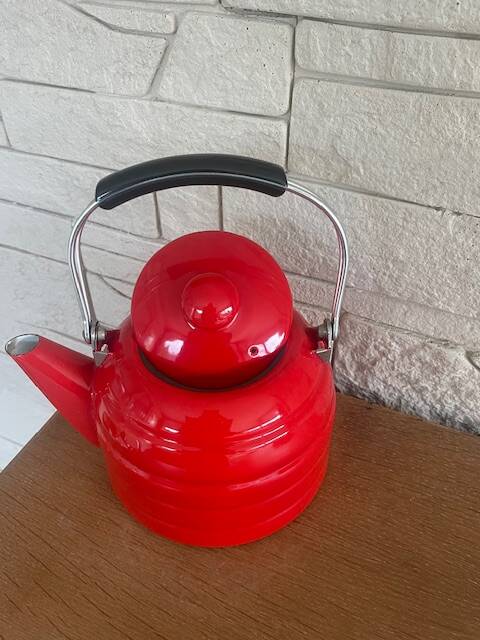 Old red enameled kettle