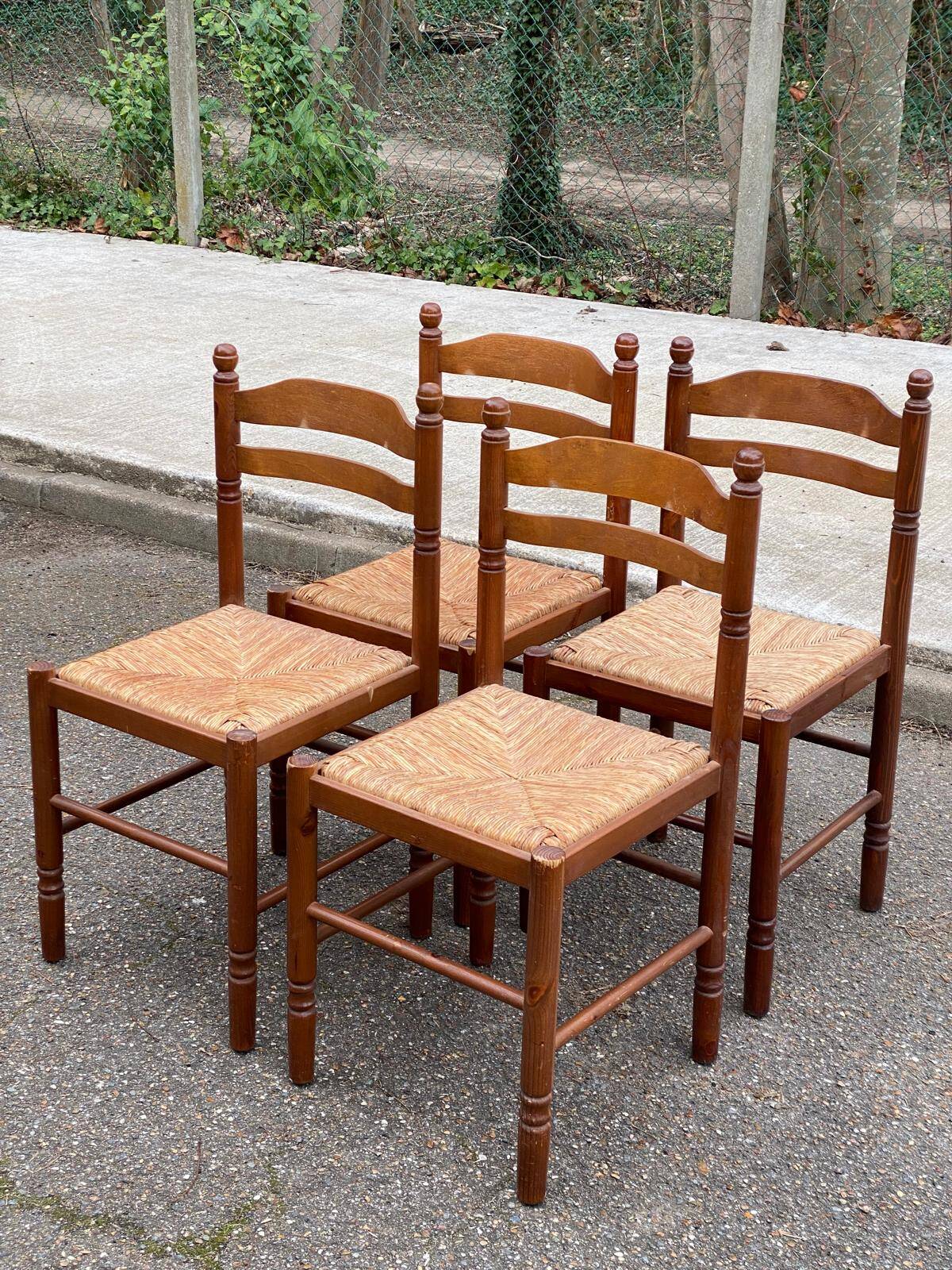 4 dining or kitchen chairs made of solid wood with rush seats.