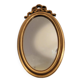 Miroir ovale à noeud doré  en bois