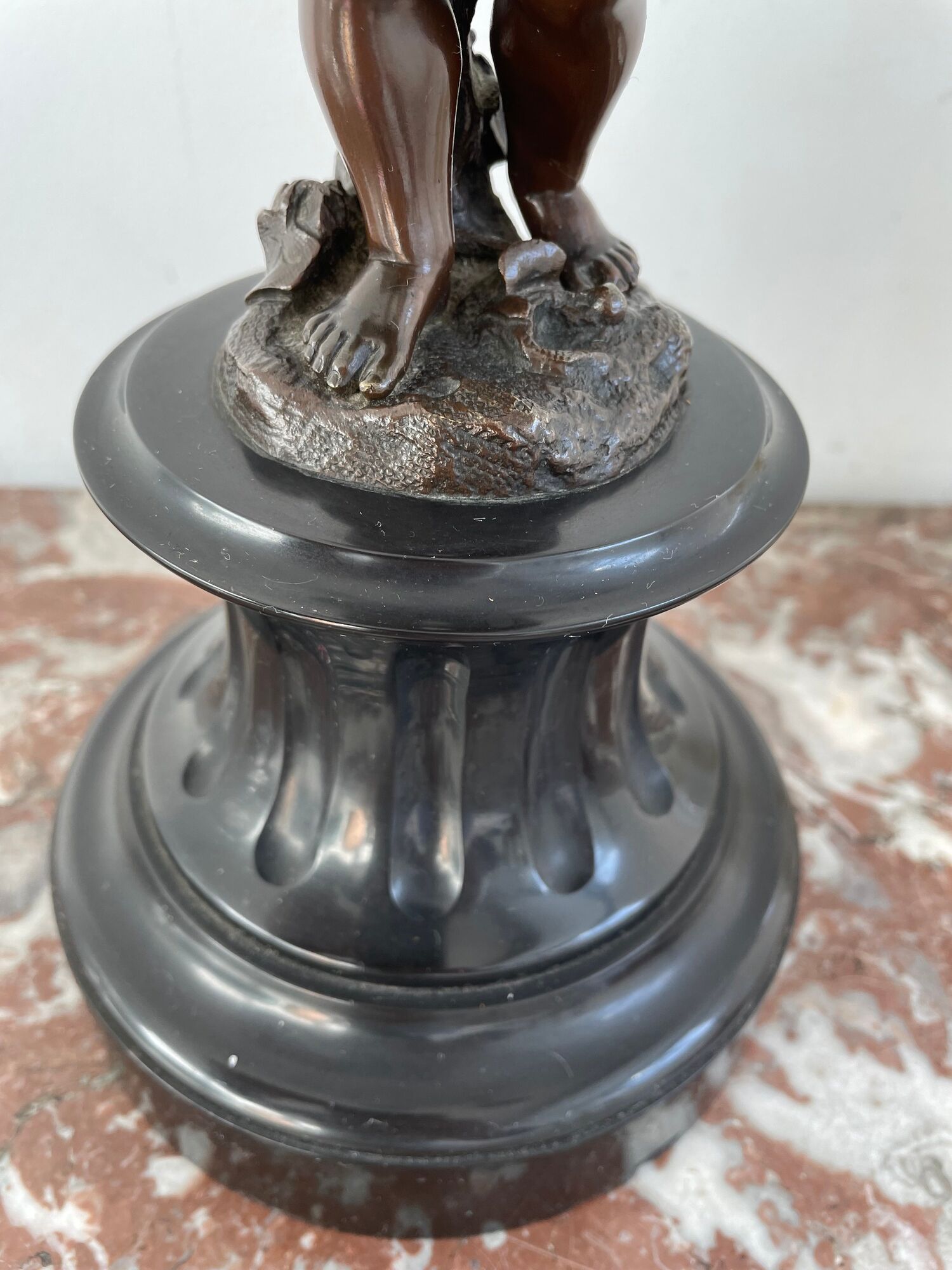 Candelabra with cherub in patinated bronze