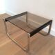 Pair of side tables in chrome, blackened wood and glass.