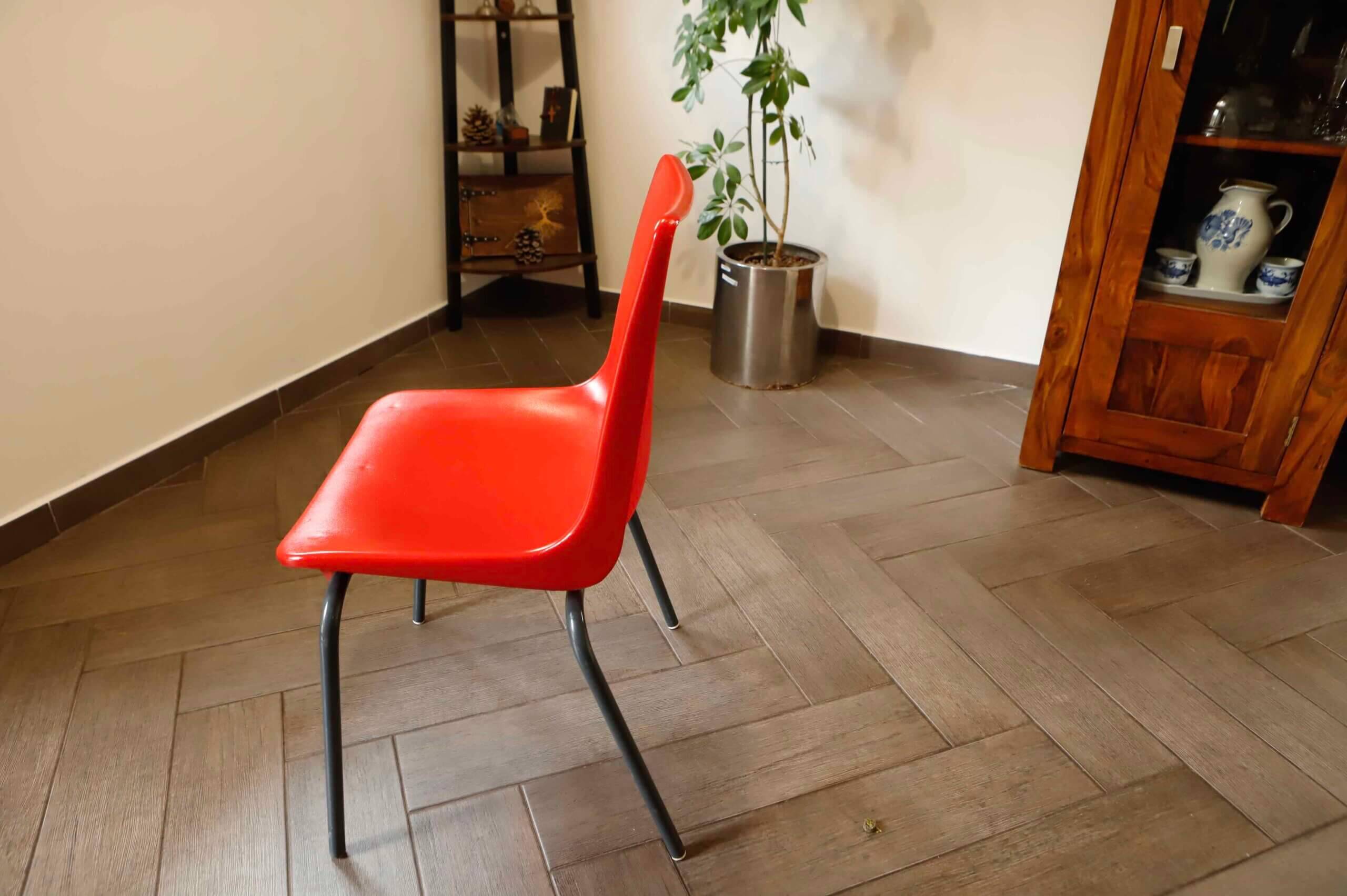 Pair of red plastic chairs with metal frame