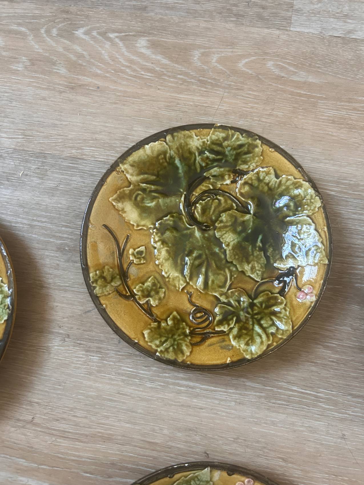 Four antique dessert plates in majolica with vine decoration.