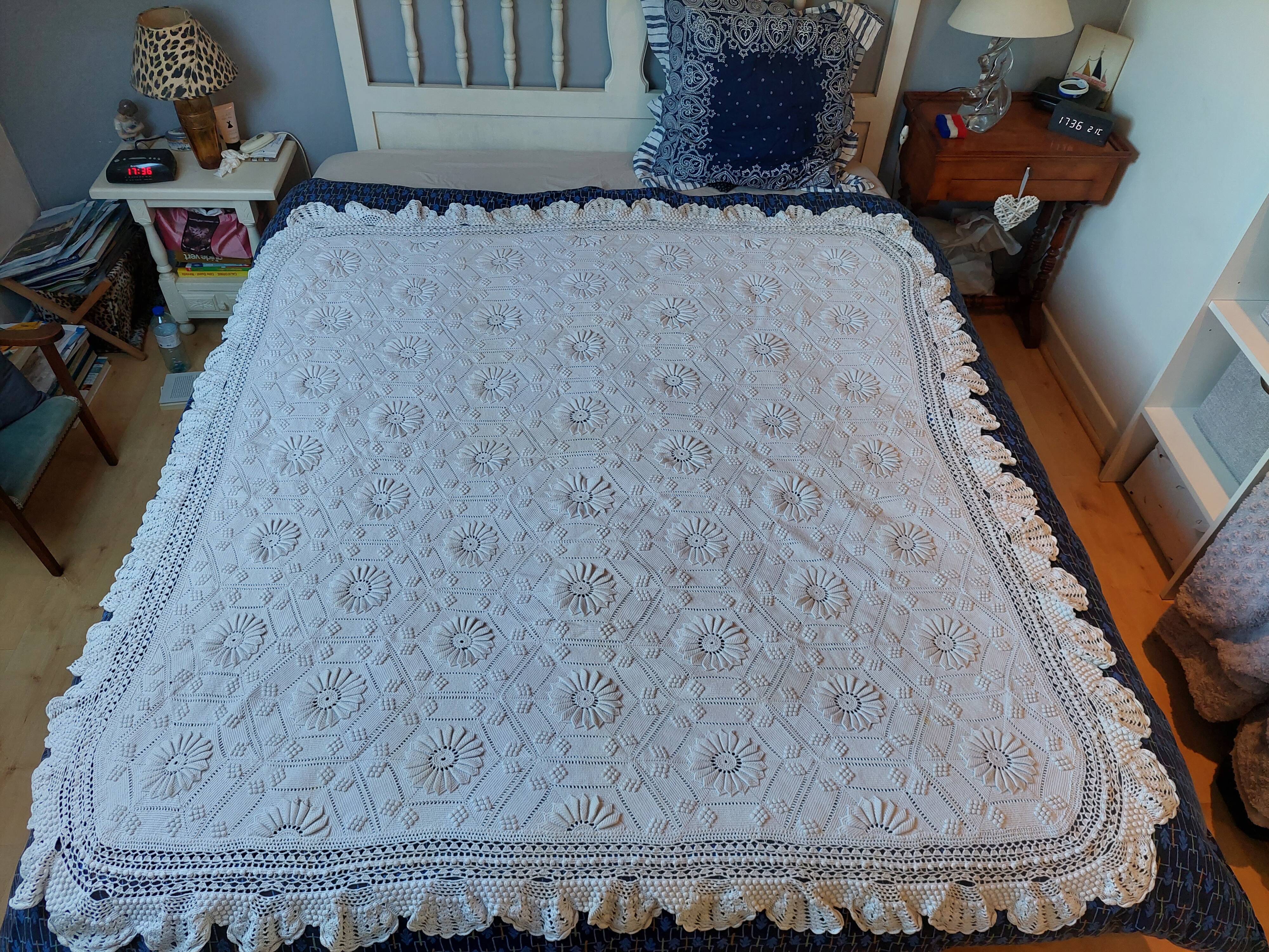 White bed throw with relief embroidery and floral patterns