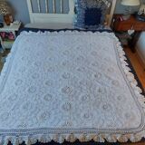 White bed throw with relief embroidery and floral patterns