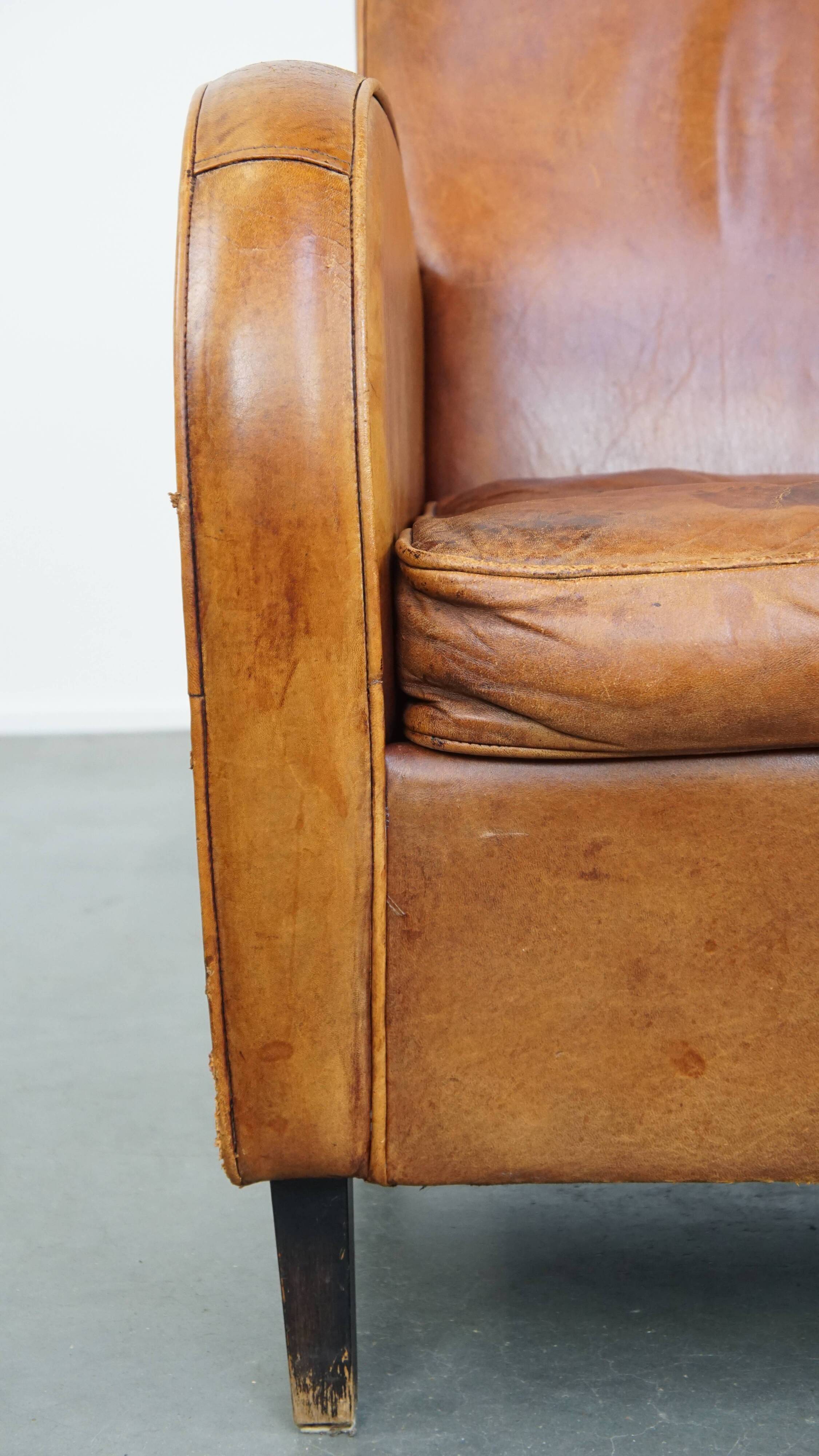 Characteristic sheepskin design armchair in beautiful warm cognac colours