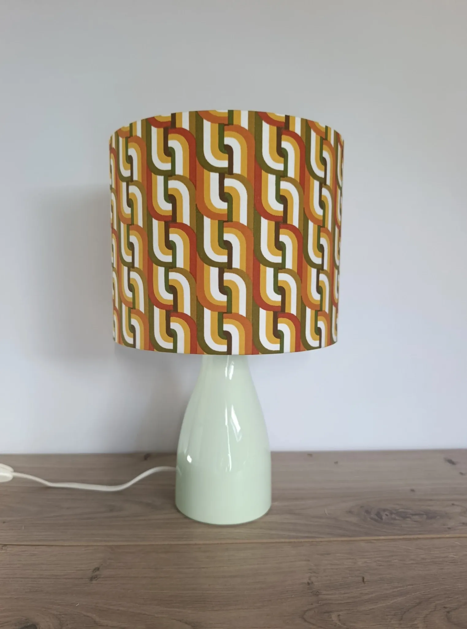 Seventies spirit lamp with geometric orange/green lampshade.