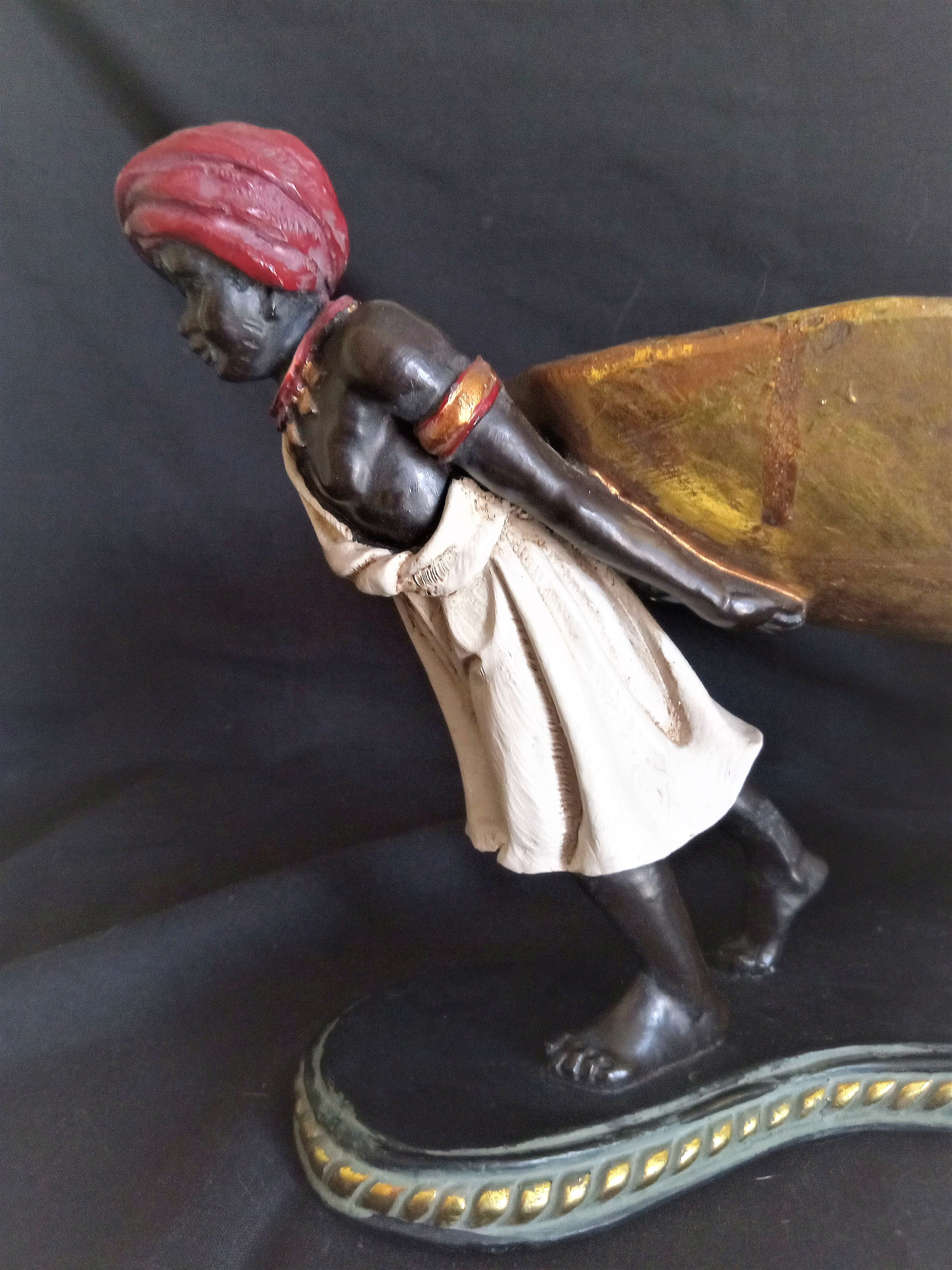 Centerpiece with African characters, plaster, resin and wood
