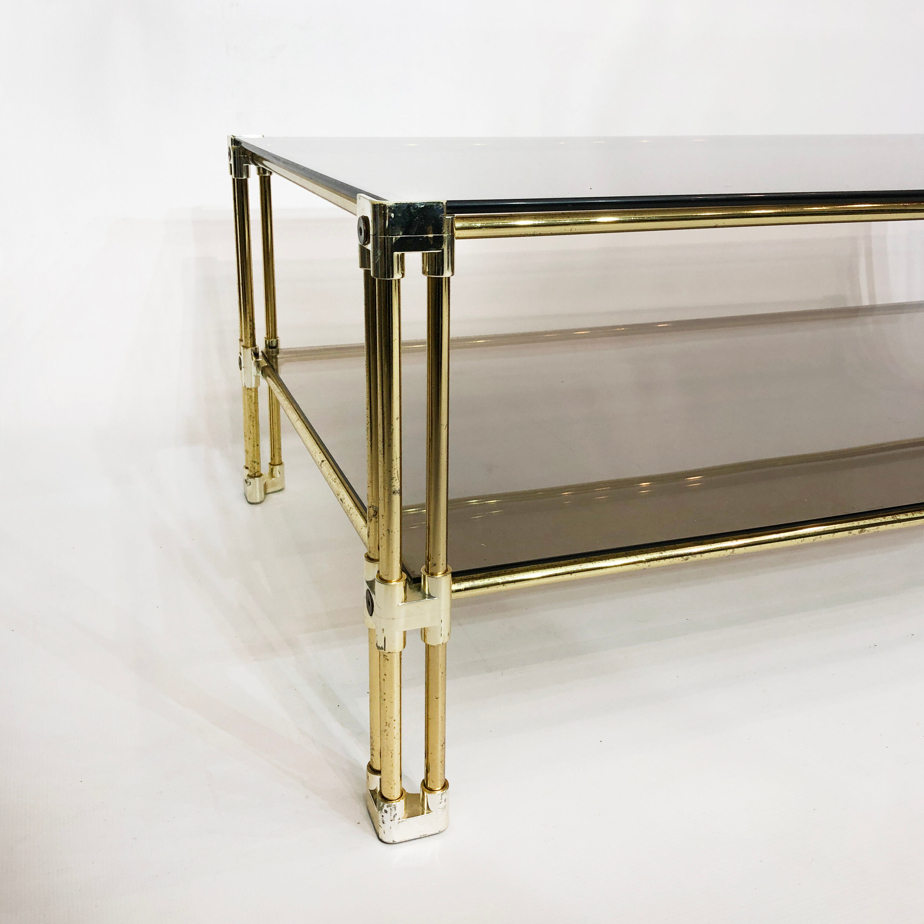 Brass two-tiered coffee table hollywood regency gold smoked glass 1970s