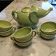 Handcrafted ceramic tea set with animal decoration.