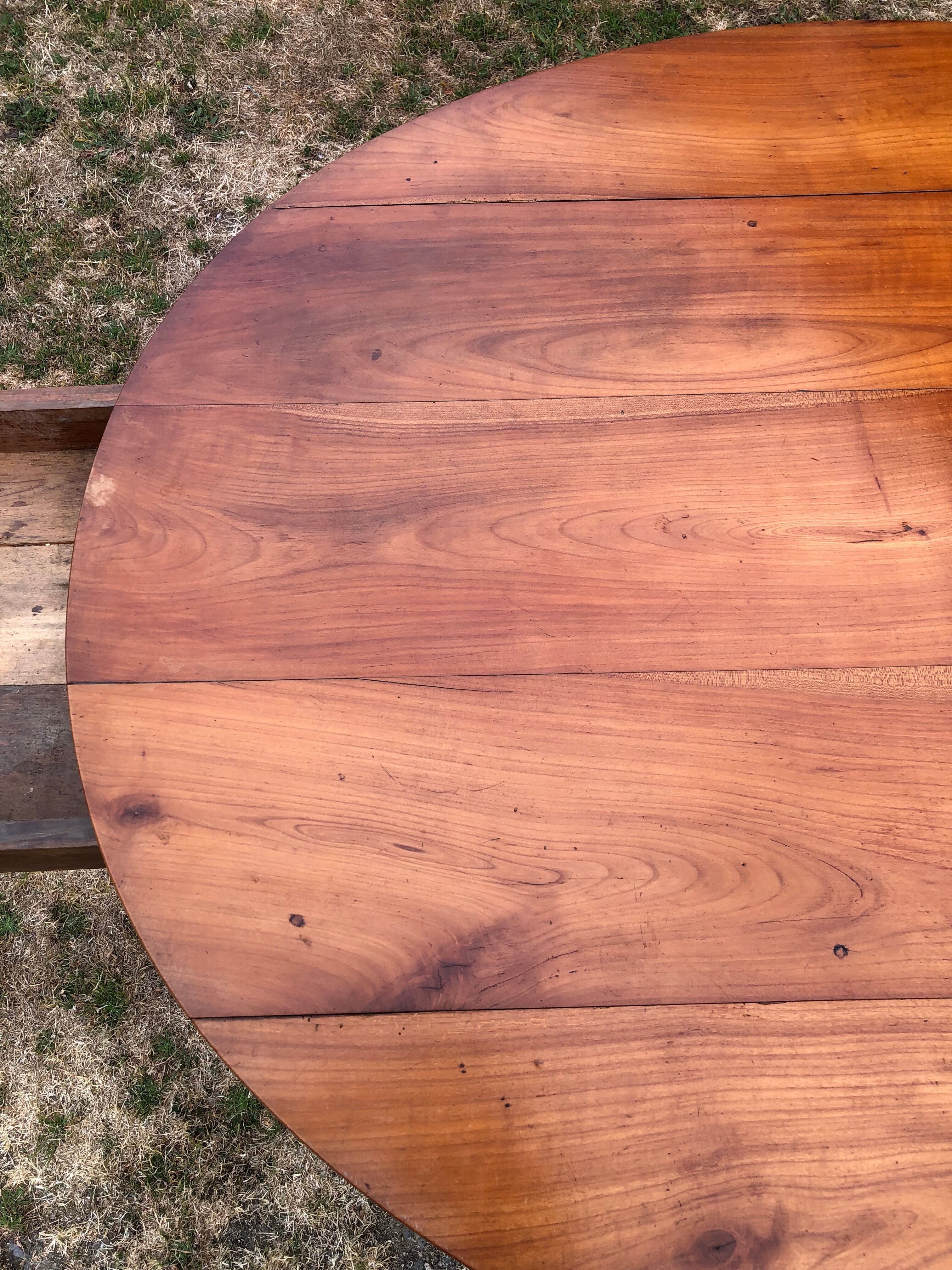 Louis Philippe oval drop-leaf table in solid cherry wood with 2 drawers.