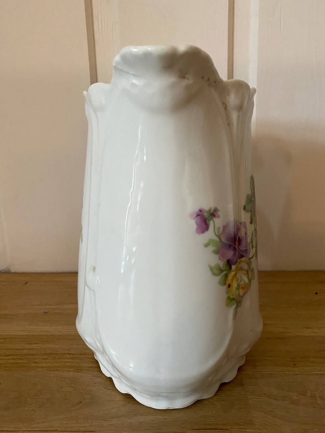 Old ceramic pitcher decorated with flowers