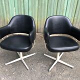Pair of vintage armchairs in black skai with metal legs.