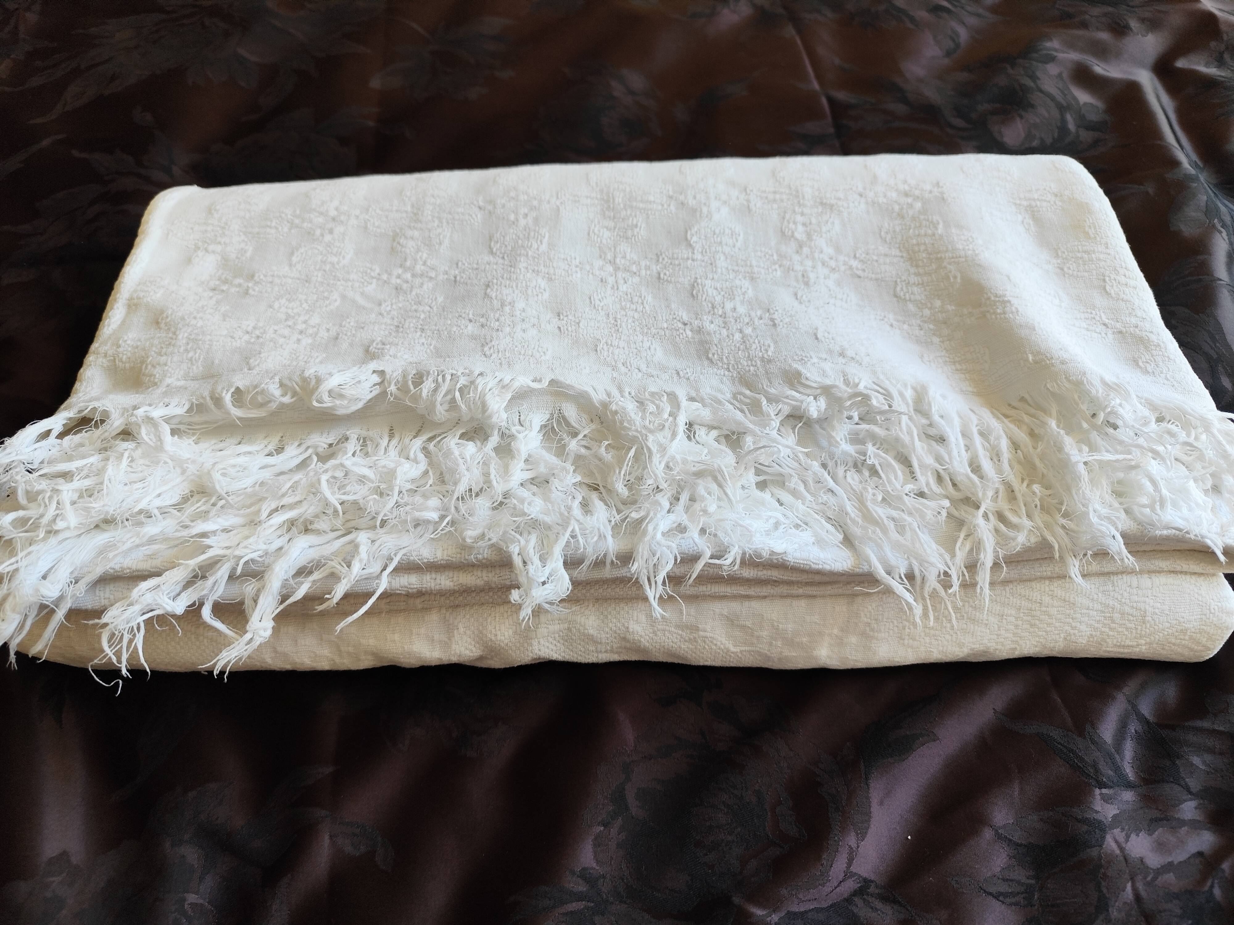 White woven cotton bedspread with fringes