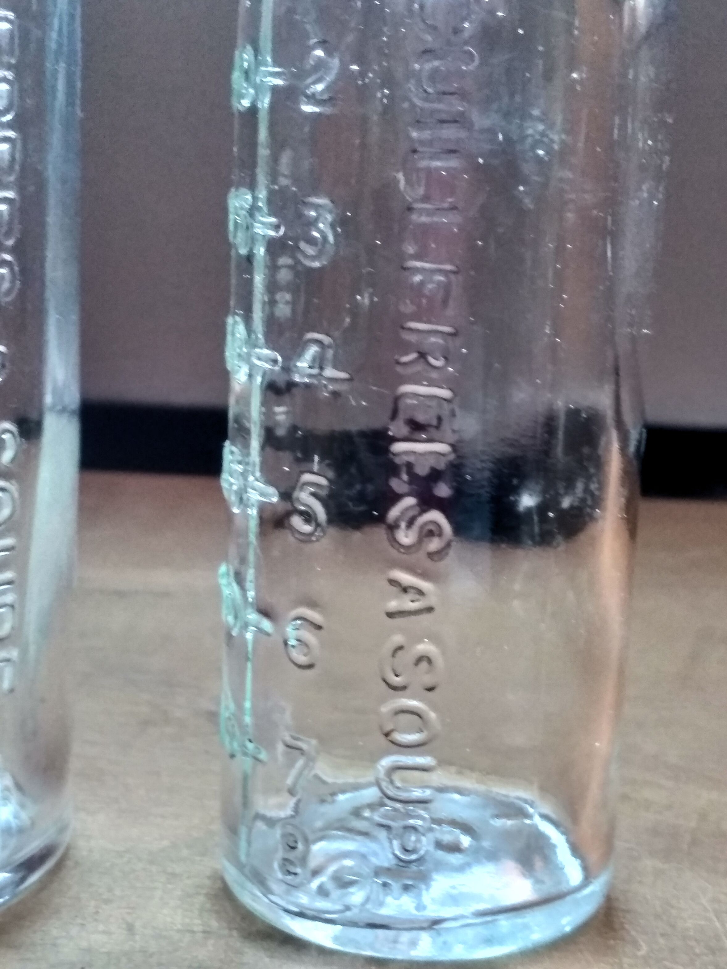 2 old graduated pharmacy bottles