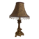 Golden baroque-style table lamp with a shade adorned with pendants.