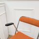 6 orange folding chairs