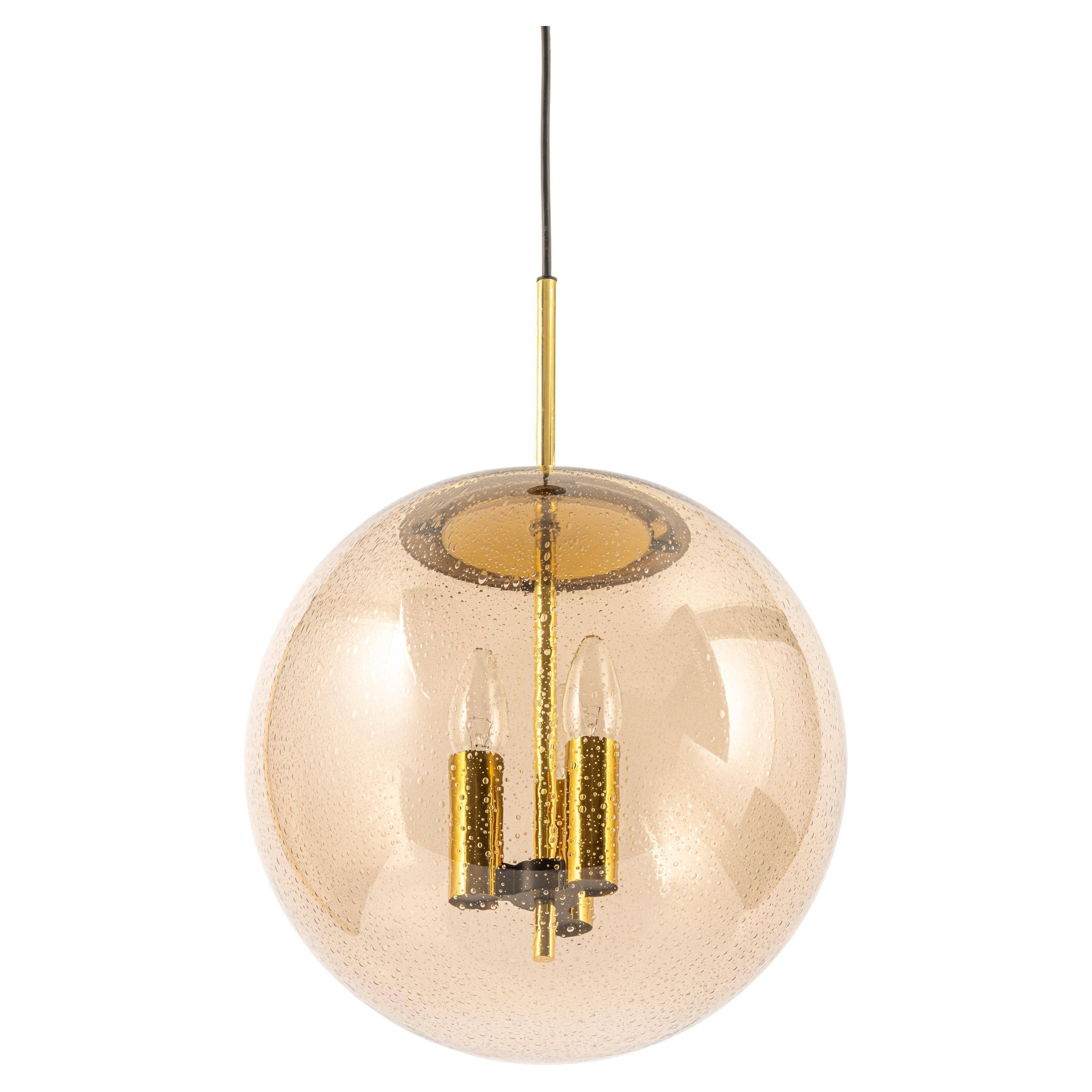 Large Limburg pendant light in brass with smoked glass ball, Germany, 1970s.