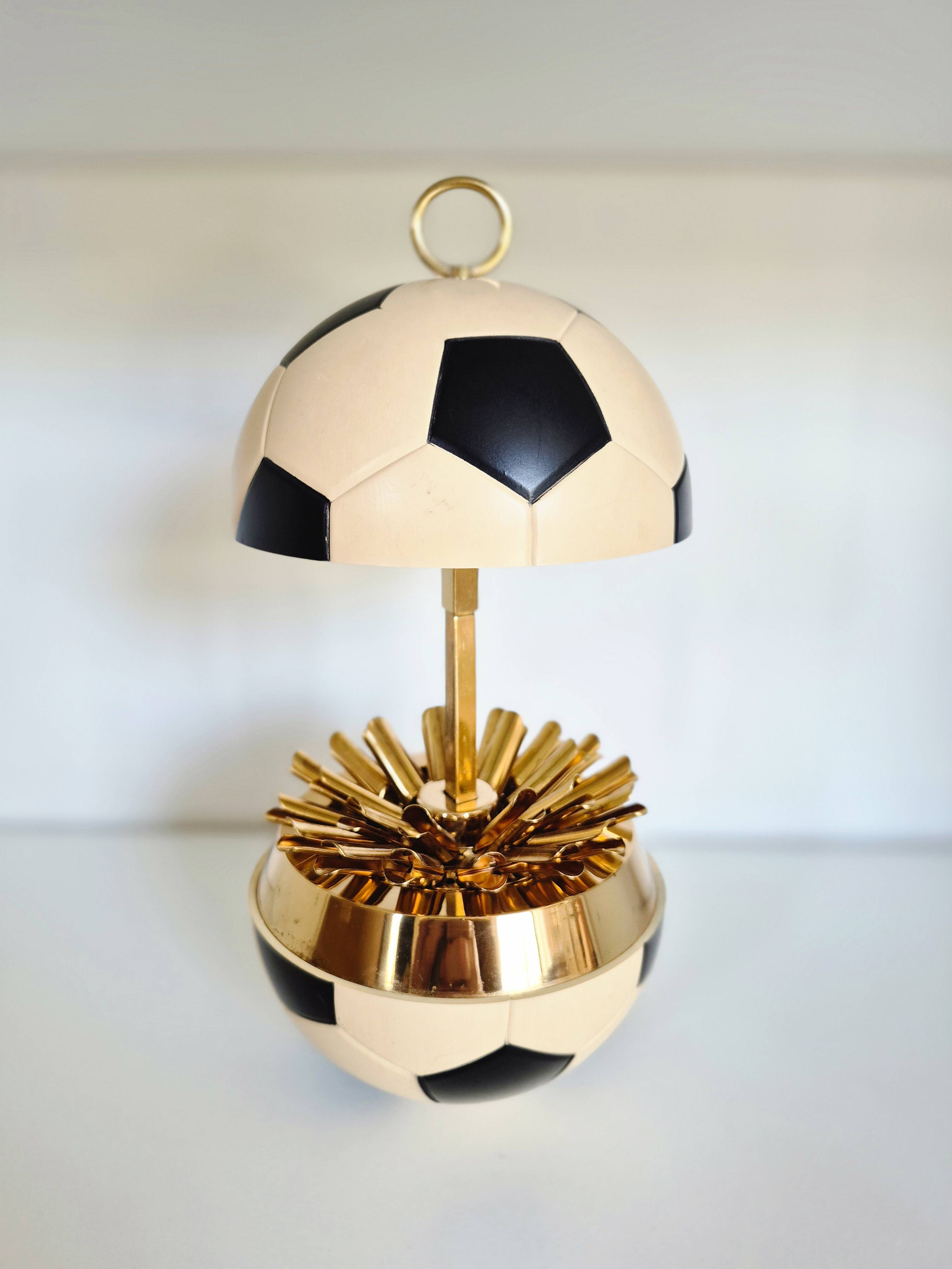 Vintage cigarette dispenser in the shape of a football.