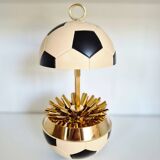 Vintage cigarette dispenser in the shape of a football.