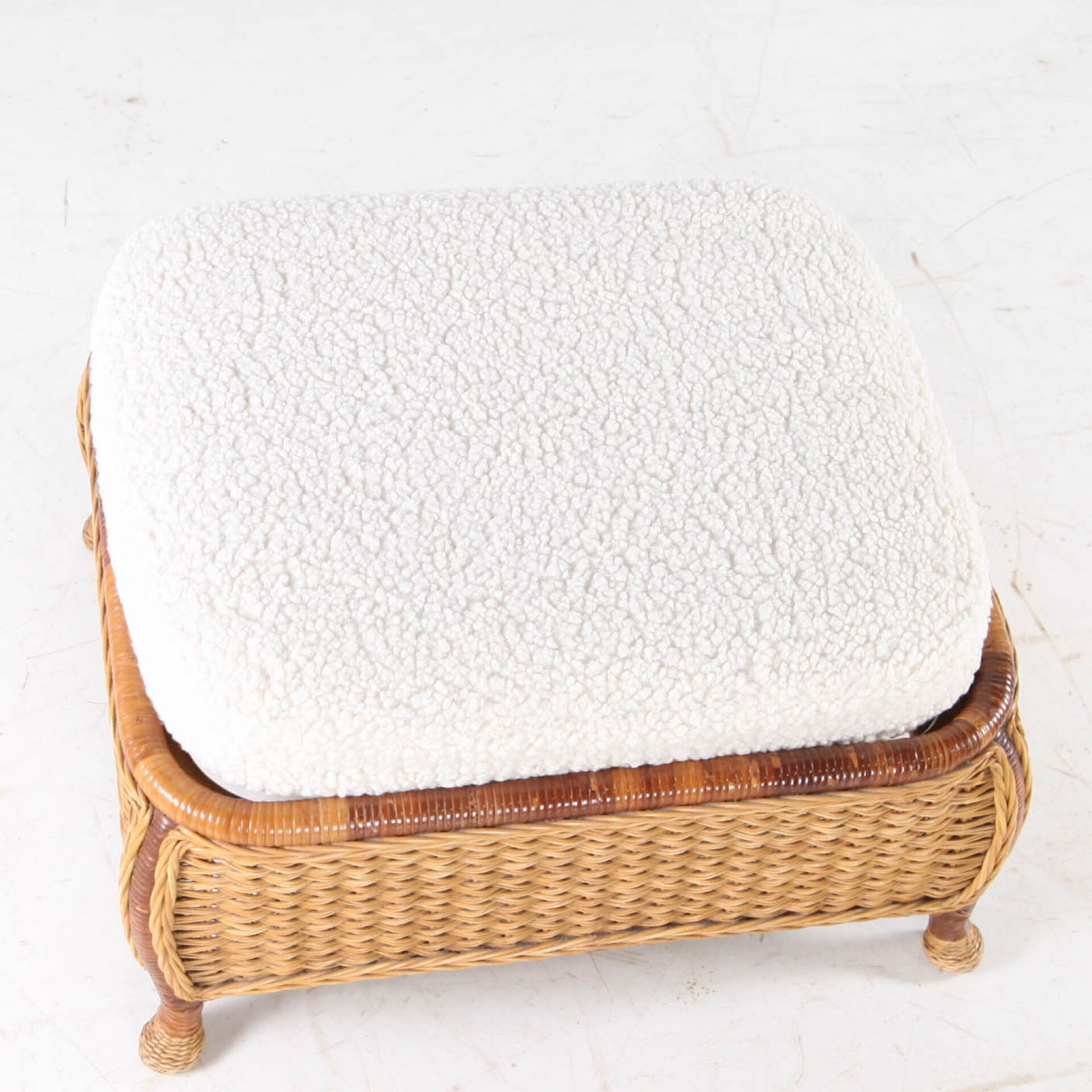 Large wicker armchair and its ottoman