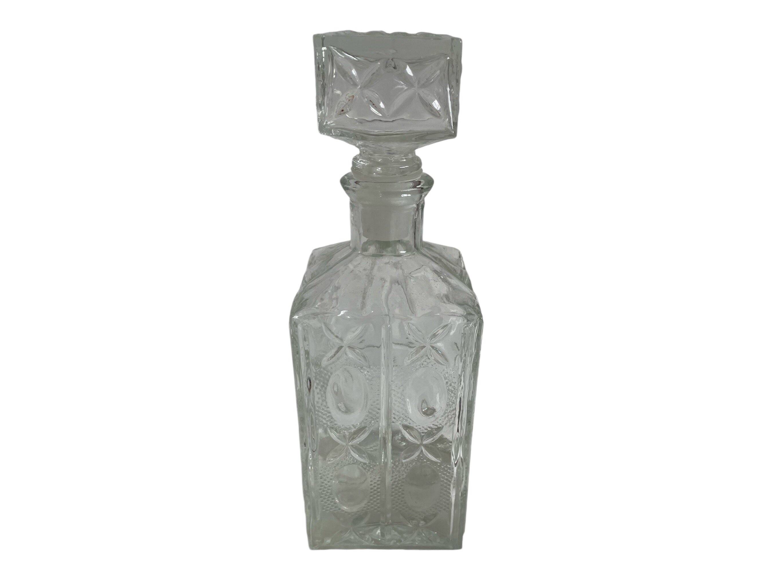 Molded glass carafe, 1960s-1970s, stylized flower decoration, oval, square base, stopper, rosette