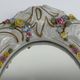 Antique porcelain mirror from Dresden with relief flowers and rococo decoration.