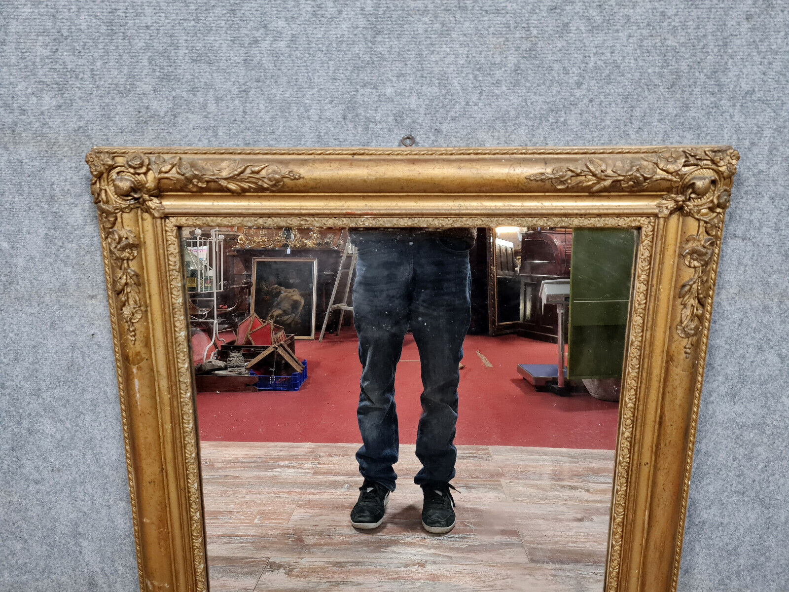 Old nineteenth century mirror in gilded wood and carved around 1850
