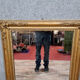 Old nineteenth century mirror in gilded wood and carved around 1850
