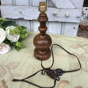 Turned wooden foot lamp with pleated lampshade